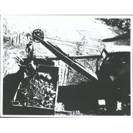 Excavator unloading into truck