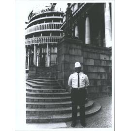 Policeman standing in front of Beehive construction