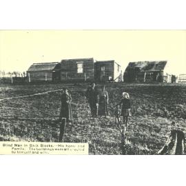 Blind man in back blocks. His home and family. The buildings were all erected by himself and wife