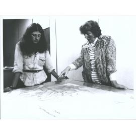 Mrs. Park, Conservation Officer, National Archives discusses conservation of a map with a temporary employee