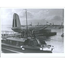 Berthed showing wartime markings - red, white & blue. Tasman Empire Airways ZK-AMC