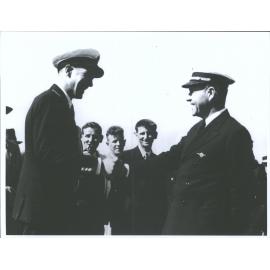 Captain Burgess (left) greeted by Captain Musick of California Clipper, Pan American Airways