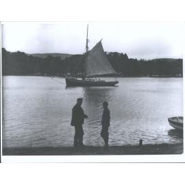 Unidentified couple in front of boat