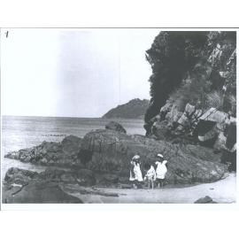 Children in a rock pool at a beach