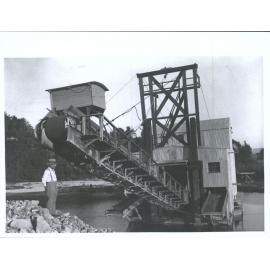 Man standing near dredge