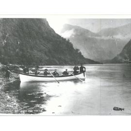 Men posing in rowboat, Wet Jacket Arm, Dusky Sound