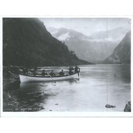 Men posing in rowboat, Wet Jacket Arm, Dusky Sound