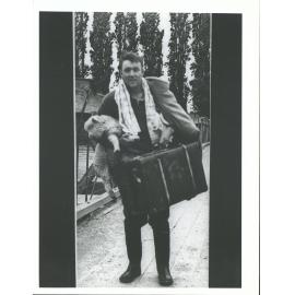 Farmer with sole possessious he picked up as he left his home waist deep in water, Baclutha Floods 1957
