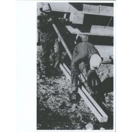 Two New Zealand drillers take core Samples from a bore made into Ross Island