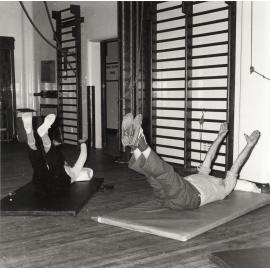 Couple performing leg lift exercises