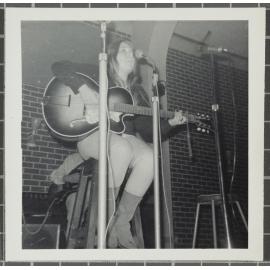 Female vocalist with guitar performing at the 'Folk Proms Concert Capping '67', Union Hall, Dunedin