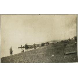 Boats and shore with unidentified human figures
