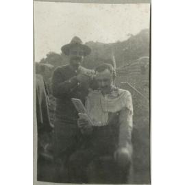 Charles Mackie Begg getting a haircut