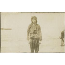 Unidentified man standing on a shore