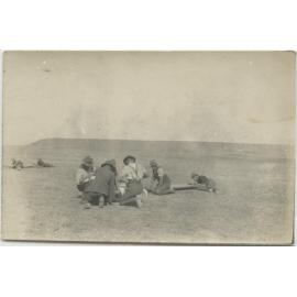 Group of men kneeling and lying on the ground