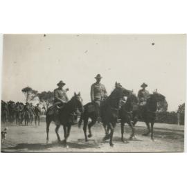 Officers on horseback, with men on foot behind them