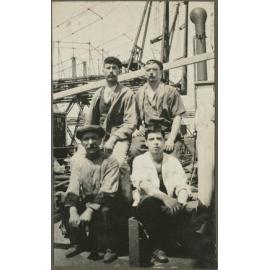 Group of four men on the deck of a ship