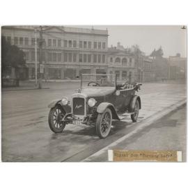'Signal for turning left', showing motorist on Cumberland Street (at Queens Gardens), Dunedin