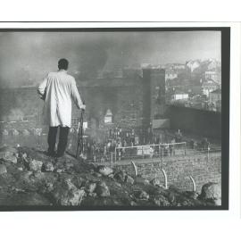 Armed guard overlooking prison exercise yard