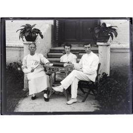 Three people seated around a table