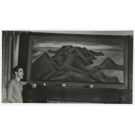 Charles Brasch in Rodney Kennedy's room at Royal Terrace with Colin McCahon's 'Otago Peninsula' above the mantelpiece