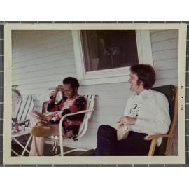 Robert Lord and another man sitting on the deck of a house