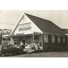Shopkeeper Bill Waugh in front of Concord Discount Store