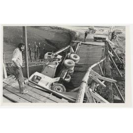 'Mr A. Paton-McDonald surveys his $20,000 mobile crane which fell into the Taieri River yesterday, when the Taieri Mouth bridge collapsed'