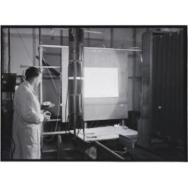 Man with photographic equipment, Coulls Somerville Wilkie, Crawford Street, Dunedin