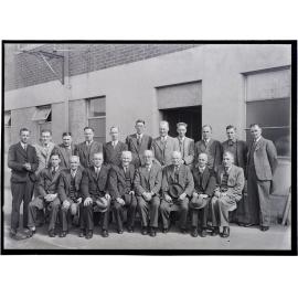 Group of male staff in front of packaging department building, Coulls Somerville Wilkie, St Andrew Street, Dunedin