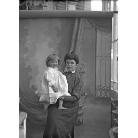 Fred McGeorge in dress, held by Ethel McGeorge