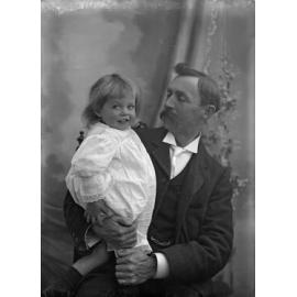 Fred McGeorge in dress, held by Ethel McGeorge