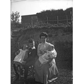 'Behind school house at Oamaru, Ve, Bert, Ethel and baby'