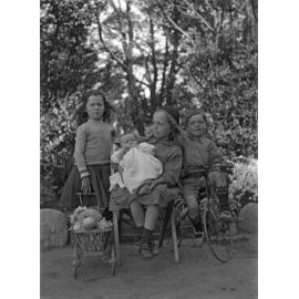 McGeorge children, Ve holding doll's pram, Em holding Alison, Fred on bike