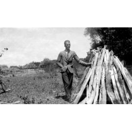 Man next to wood pile
