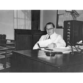 Sir John Walsh at his desk, Dean's Office, Dental School, University of Otago
