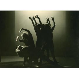 Five dancers, arms raised like claws