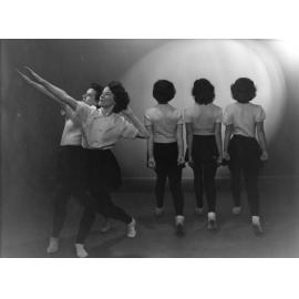 A group of two facing left and three facing away from camera