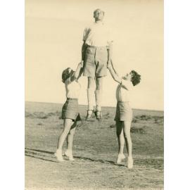Philip Smithells and two women in outdoor gymnastic demonstration