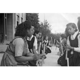 Girls playing stick game