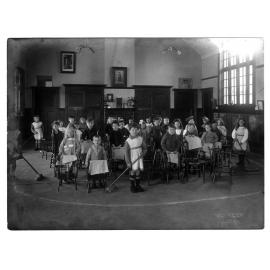 Children with brooms and cloths