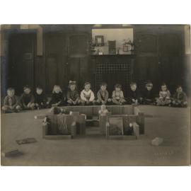 Children sitting indoors on the floor