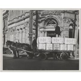 Bales of rabbit skins on a cart at the corner of Crawford Street and Rattray Street