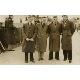 Four men in coats
