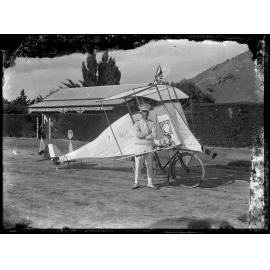 Man standing beside 'Night Owl' bicycle-powered plane