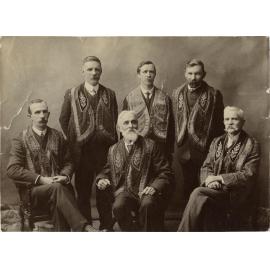 Six men wearing regalia