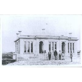 [Men outside building]