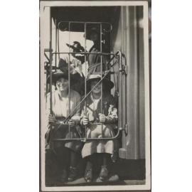 Four Te Wai Pounamu College girls behind metal gate