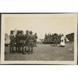 Soldiers at camp, a group is having a photograph taken