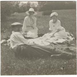 Picnic scene showing a man and two women